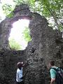 Meno showing Ross the shells in the building materials of the church